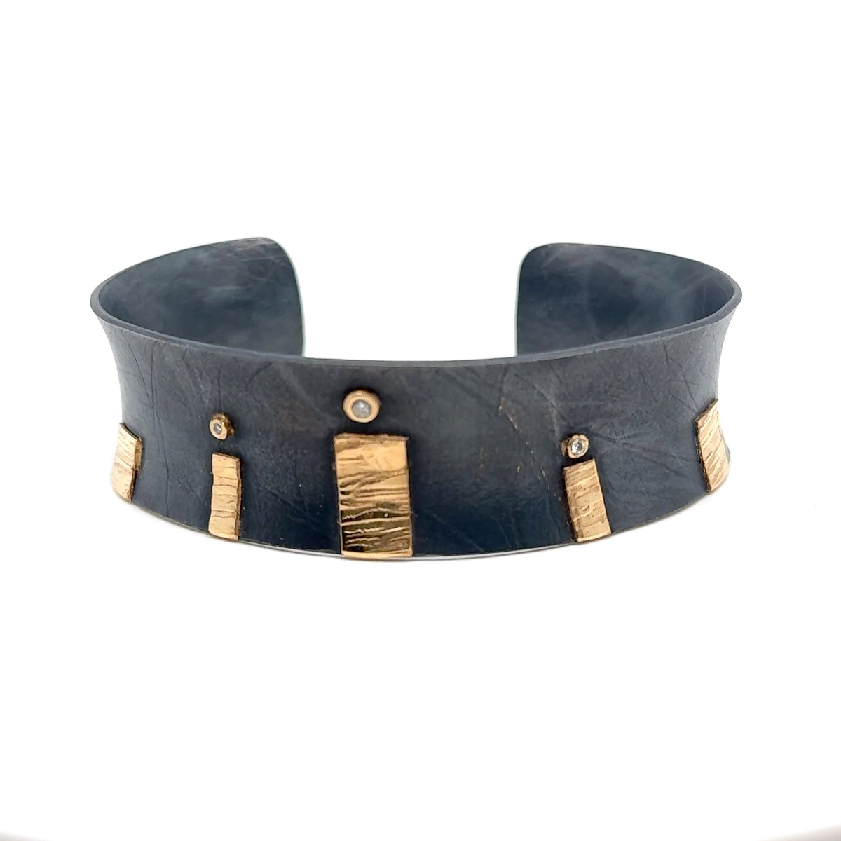 1" wide oxidized sterling silver cuff with 14K rectangles topped with diamonds in  14K circular bezel settings