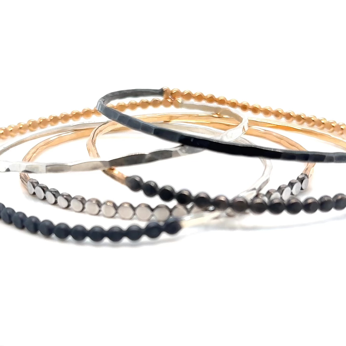 video of group of handmade beaded hammered bangles